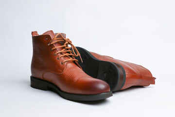 Brown men's leather shoes on a white background. Fashion trend. Winter season half-boots.