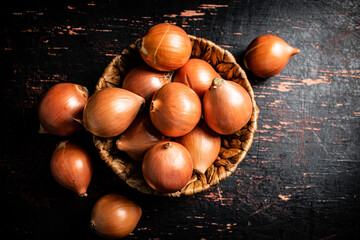 A full basket of onions on the table. 