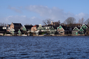 Fototapeta premium Traditional Dutch buildings standing by the river.