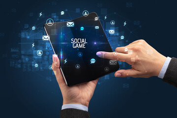 Businessman holding a foldable smartphone, social media concept