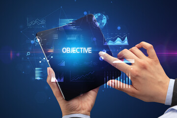 Businessman holding a foldable smartphone, business concept