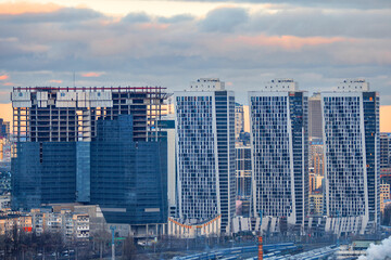 Active construction of residential skyscrapers against the background of the urban landscape.