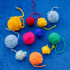 Colorful yarn balls on blue background