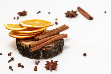 Cinnamon sticks and dry orange chips on hemp.