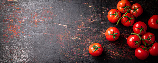 Fresh fragrant tomatoes on a branch.