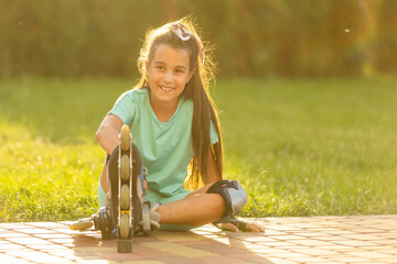 Little girl in roller skates at a park.