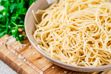 Boiled spaghetti in a plate with parsley. 