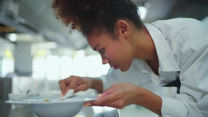Beautiful female chef preparing food before serving at kitchen in restaurant. Chef, Lifestyle, Education, Happiness, Cheerful concept.