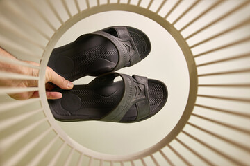 Old household slippers are thrown into the trash for disposal and recycling. View from below. The...