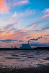 sunset over Dublin Bay, with electricity power plant