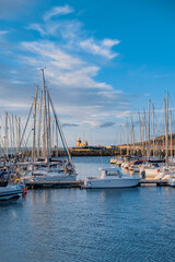 Fototapeta premium boats in the port with lighthouse at the end, Howth, Dublin, Ireland
