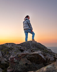 Fototapeta premium person on the top of the mountain at sunset, climb to the top, Bray, Ireland