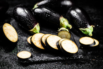 Pieces of ripe eggplant on a stone board. 
