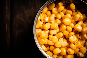 An open can of canned corn. 