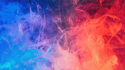 Color smoke abstract background. Cold hot. Ice fire flame. Defocused blue red contrast paint splash...