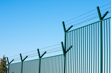 Fence with barbed wire. Refugees fence camp migration border.