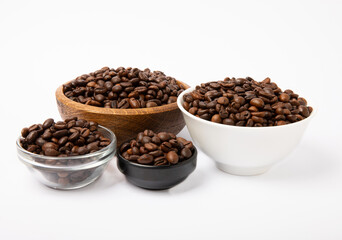 Coffee beans in bowl isolated on white background.