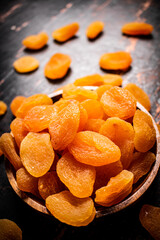 Full wooden plate with dried apricots. 