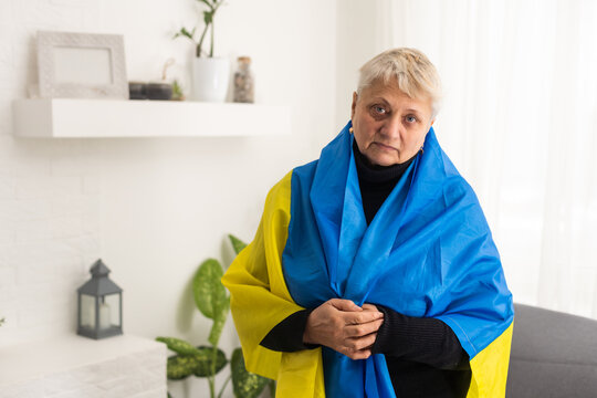 an elderly woman with a flag of Ukraine - Powered by Adobe