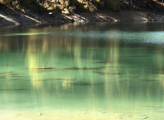 Obraz na płótnie Canvas Teal waters of Lake Cauma, jewel of the Swiss Canton of Grisons