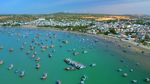 Fishing village in Mui Ne, Vietnam. Mui Ne Fishing Village, flying around several hundred fishing boats anchored to avoid storms, is a beautiful bay in central Vietnam. Asia fishing boats. 4K