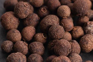 big pile of natural allspice in peas