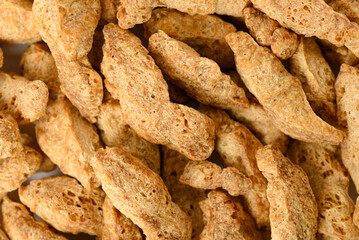Layer of pieces dry textured soy protein or vegan meat as food background