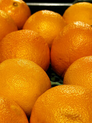 Shop counter with ripe yellow oranges. Fruits and vegetables selling