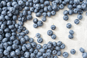 Fresh blueberries on gray background. Blueberries background. Healthy berry, organic food, antioxidant, vitamin, blue food.