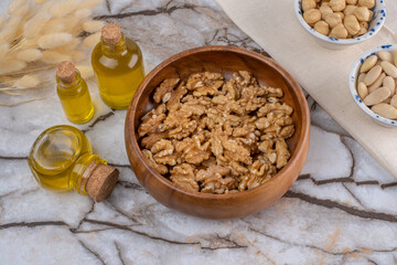 Talnuts On Wooden Plate, Oils in Small Bottles, Still Life Concept.