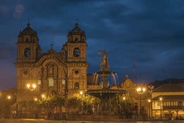Fototapeta na wymiar Inca Fountain and Church de la Compania de Jesus at Main Square - Cusco, Peru, the blue hour