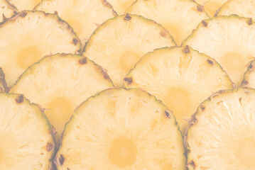 Pineapple juicy yellow slices background. Top view.