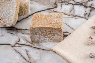 Handmade Textured Natural Bar Soap on Marble Floor, Bathroom Floor Concept.
