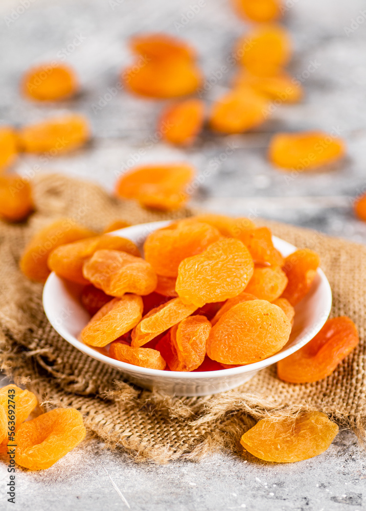 Wall mural Fragrant dried apricots in a bowl on the table. 