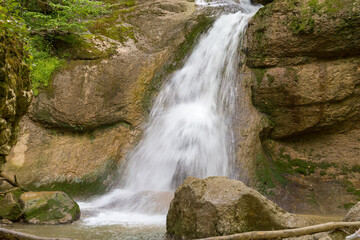Obraz premium Summer, mountainous terrain, hiking trails running through the park, with a view of the waterfall and places for walking and relaxing.