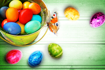 Easter background with colorful easter eggs on wooden background.