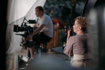 Director at work on the set. The director works with a group or with a playback while filming a...