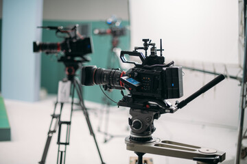 A professional film and video camera on the set. Filming day, equipment and crew. Technique of...