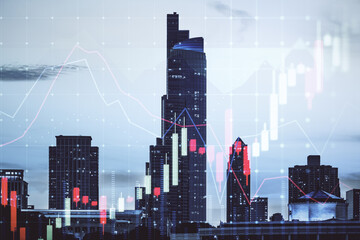 Obraz premium Glowing forex chart on blurry city background. Trade, finance and invest concept. Double exposure.