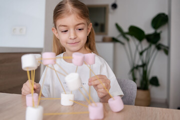 girl making molecular model learning  chemistry science at home. 