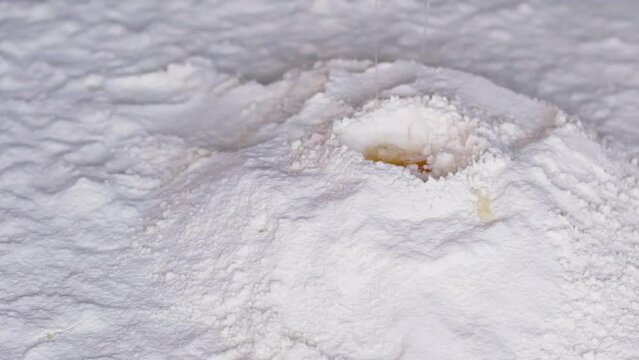beautiful falling eggs into flour falling in one place in one funnel flour Full HD 240 fps delicious pastries close-up space for text of beginning of cooking show space for titles and advertising logo