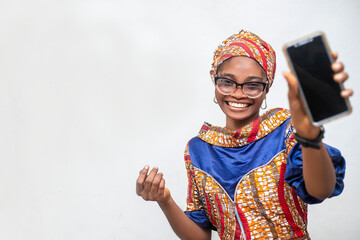 Selective focus of young African woman holding phone screen to camera