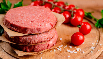 Raw burger with tomatoes. 