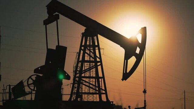 Business. Energy mining platform. Oil rigs in an oil field for extraction of fossil fuels and crude oil from underground. Tower with pump for fossil resources. Drilling ground research.Industrial oil