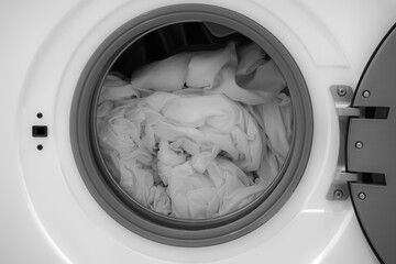 open drum of a washing machine washing white bed linen. Rotating drum in a washing machine tub with clothes. front washing machine and taking clean wet laundry. Unloading washing machine. Housekeeping