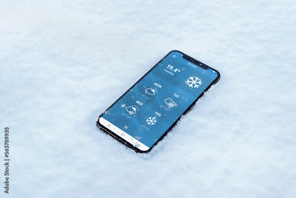 Wall mural phone in the snow with a weather app. temperature in fahrenheit with forecast for several days