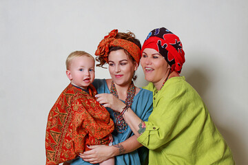 Grandmother mom and grandson in bright clothes on a white background