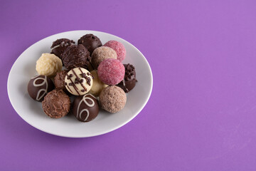 photo of various round-shaped sweets lying on a plate