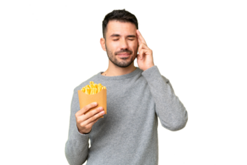 Young caucasian man holding fried chips over isolated chroma key background with headache