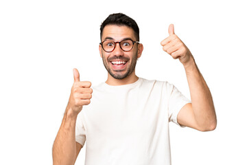 Young handsome caucasian man over isolated chroma key background giving a thumbs up gesture - obrazy, fototapety, plakaty